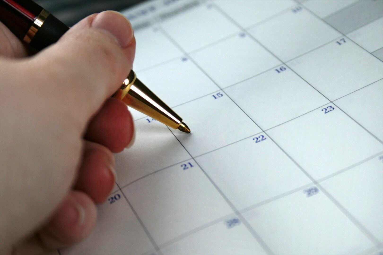 A person writing on a calendar